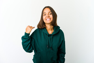 Young mixed race woman laughing about something, covering mouth with hands.