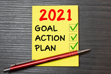 Goal,plan,action text on notepad with office accessories.