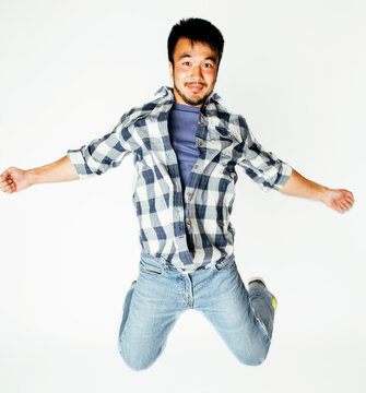 young pretty asian man jumping cheerful against white background, lifestyle people concept isolated