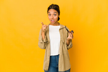 Young hispanic woman holding a smoking pipe having an idea, inspiration concept.