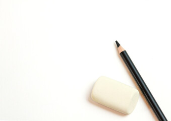 black pencil on a white background with an elastic band