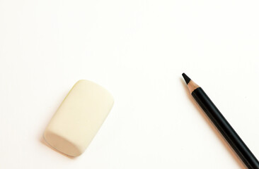 black pencils on a white background with an elastic band
