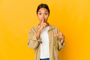 Young hispanic woman holding a pocket watch keeping a secret or asking for silence.