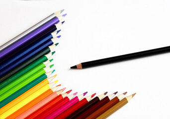 colored pencils and black pencil on a white background