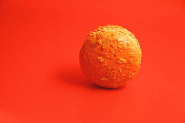 Salted Caramel macaron on red background
