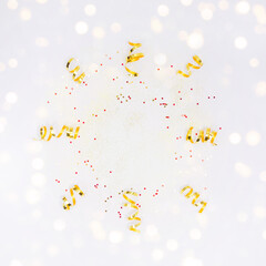 Frame with golden decorations, confetti, sparkles, lights on white background. Christmas, New year, party, wedding, birthday Flay lay copy space