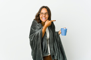 Young latin woman with blanket isolated on white background