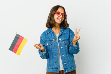 Young latin woman holding a german flag isolated on white background