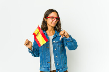 Young spanish woman holding a flag isolated on white background