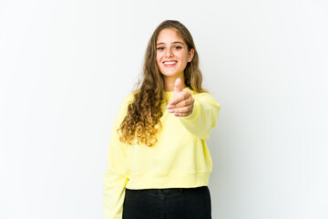 Young caucasian woman stretching hand at camera in greeting gesture.