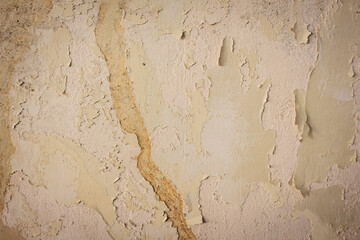 Rain water leaks on the wall causing damage and peeling paint