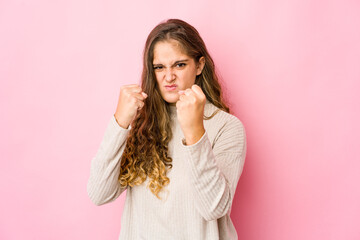 Obraz premium Young caucasian woman showing fist to camera, aggressive facial expression.