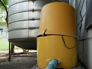 old automatic water pump and water tank at home.