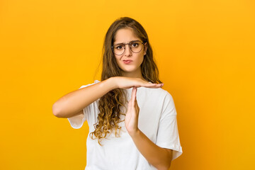 Young caucasian woman showing a timeout gesture.
