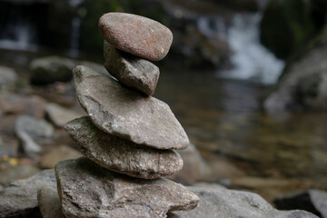Fototapeta na wymiar meditation rocks with a waterfall background