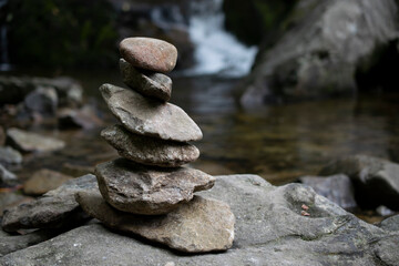 meditation rocks with a waterfall background