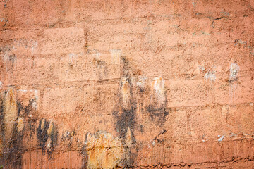 Rain water leaks on the wall causing damage and peeling paint