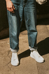 Man in blue jeans white high top sneakers mockup dark tone