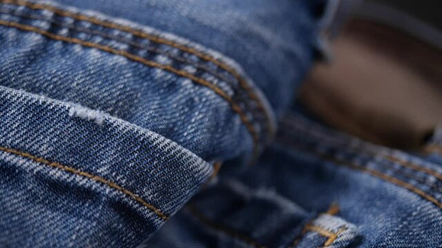 Close-up of blue denim jeans texture in dolly shot