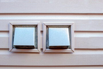 Fototapeta premium Front view air wall cap. Vent cap outside building. Furnace duct outside of a residencial house
