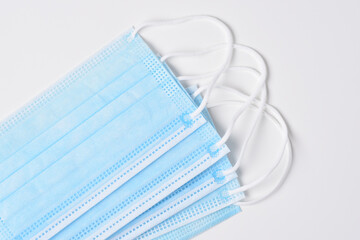 Closeup of a group of medical masks on a white background.