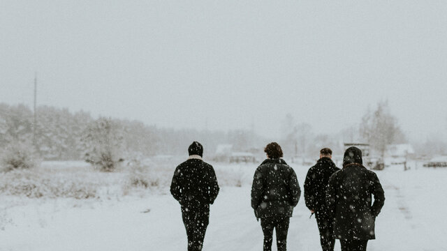 Group of men walking in the snow