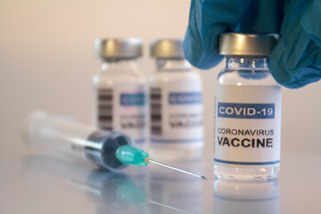 Doctor holding injection vial with Coronavirus or Covid-19 vaccine