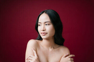 Obraz premium Beauty asian young woman black hair with perfect skin clean isolated on red background.