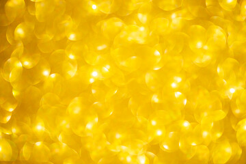 Abstract blurred golden bokeh light background, Festive season concept background, shiny gold glitter bokeh background
