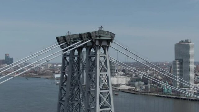Smooth Orbit of Williamsburg Bridge Arches Revealing Empire State Building Skyline in the Distance