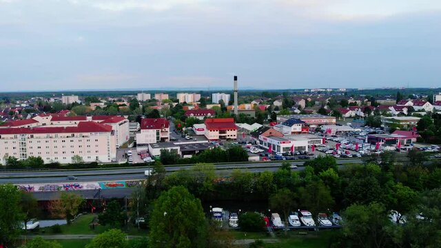Aerial view overlooking the cityscape of the Raunheim town, cloudy evening, in Germany - tracking, drone shot