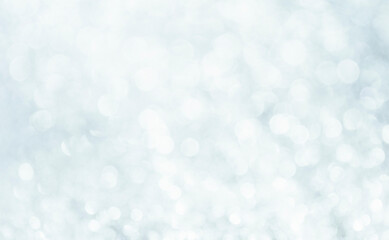 White glitter blur vintage lights background. Bokeh silver and white. de-focused celebration.