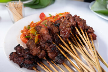 One of the typically Indonesian foods is satay or sate. This food is made from beef or mutton or chicken which is grilled over smoky coals then served with peanut sauce and soy sauce.