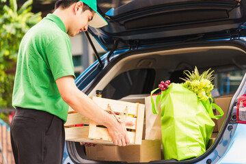 Asian delivery man grocery prepare service giving fresh vegetables food and fruit full in wooden...