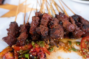 One of the typically Indonesian foods is satay or sate. This food is made from beef or mutton or chicken which is grilled over smoky coals then served with peanut sauce and soy sauce.