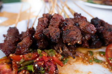 One of the typically Indonesian foods is satay or sate. This food is made from beef or mutton or chicken which is grilled over smoky coals then served with peanut sauce and soy sauce.