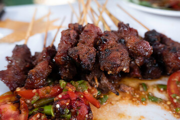 One of the typically Indonesian foods is satay or sate. This food is made from beef or mutton or chicken which is grilled over smoky coals then served with peanut sauce and soy sauce.