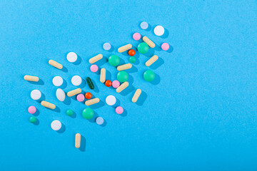 Many colored scattered pills and tablets, supplements for disease, medicines set
