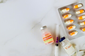 Vaccine vial SARS-Cov-2 injection prevention immunization of COVID-19 vaccines in syringe injection and medicine pills, tablets and capsules