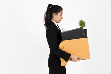 Obraz premium Fired dismissal young Asian business woman in suit holding box with personal belongings on white isolated background. Unemployment, failure and layoff concept.