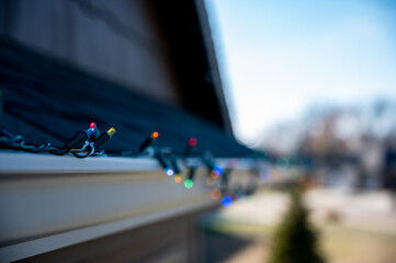 Hanging Christmas lights on gutter with plastic clips
