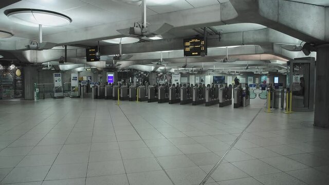 Covid-19 Coronavirus lockdown pandemic in London Underground tube train in England, UK showing one person at Westminster station, empty, quiet and deserted