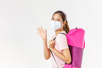 Asia woman trying to do sport during coronavirus crises despairing of the world. Portrait of a woman exercising wearing a facemask and holding a yoga mat - COVID-19 pandemic lifestyle concepts

