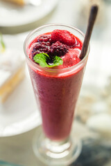 Berry smoothie Served in a tall glass in the restaurant