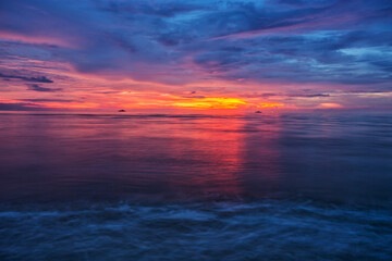 Fototapeta na wymiar Beautiful sunrise in the sea on the beach