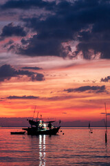 Naklejka na ściany i meble sunset in the sea with fishing boat in thailand