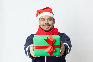 Happy asia young man holding Christmas gifts on white background
