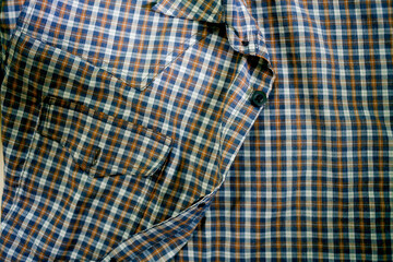 blue plaid fabric shirt with button and pocket