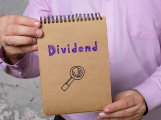 Business concept meaning Dividend with sign on the sheet.