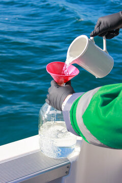 Sampling of sea water. Laboratory dishes on the background of the sea. Marine ecology concept. 